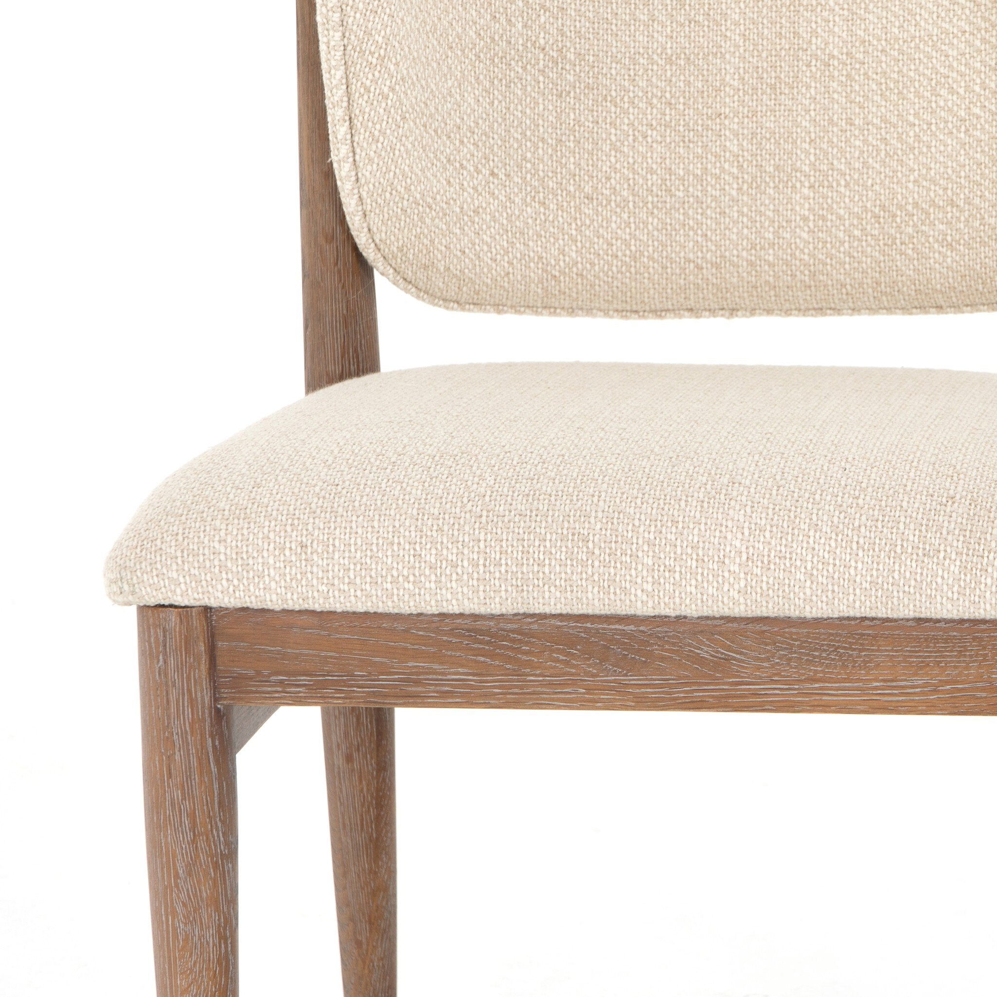 Close-up Mid-century modern dining chair with pecan wood frame and upholstered seat fabric swatch