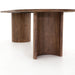Close-up Paden Dining Table in Seasoned Brown Acacia with crescent-shaped legs and an oval tabletop
