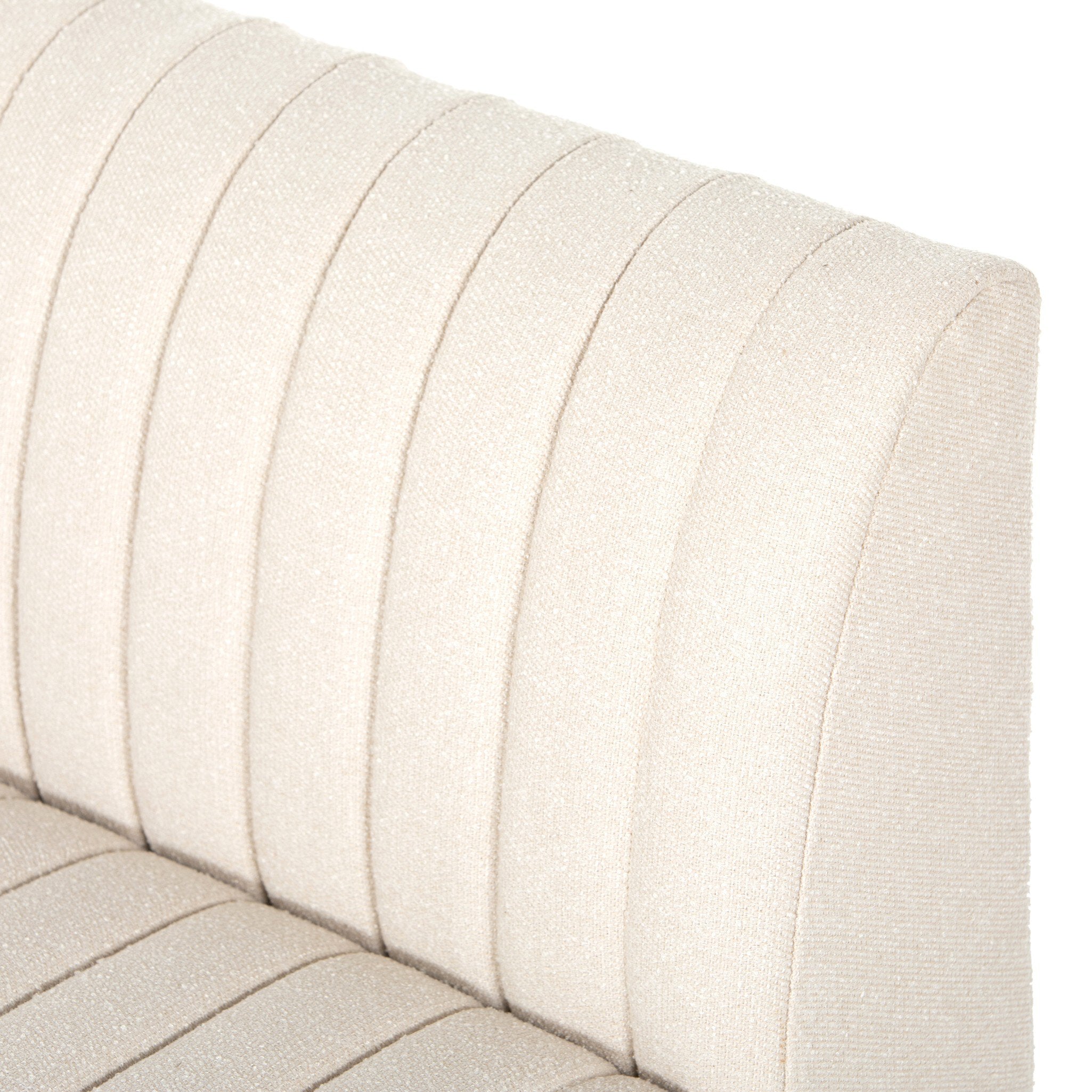Close-up custom Augustine dining center banquette in neutral performance fabric with high-back tufted detailing and wood base.
