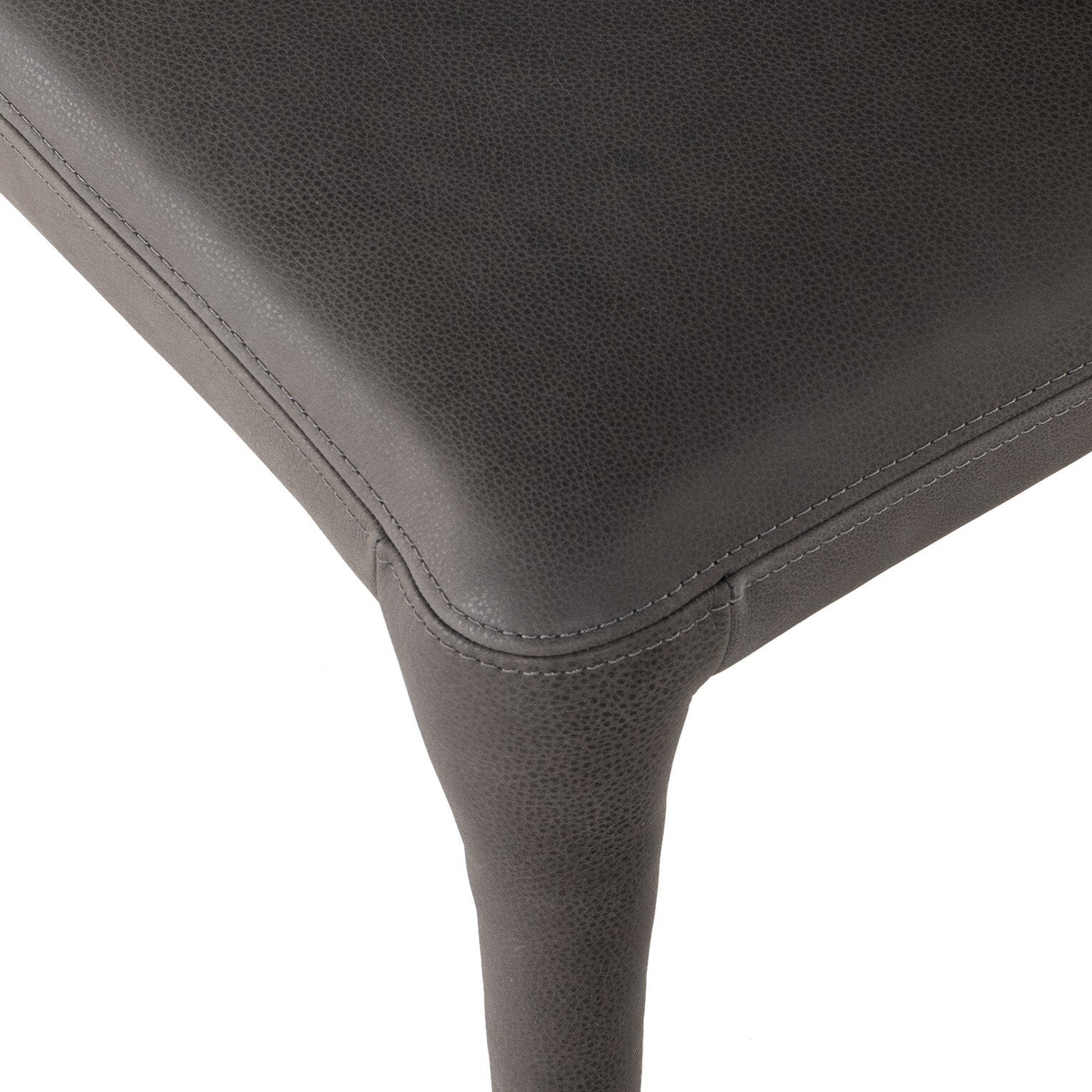 Close-up fabric detail of sleek gray dining chair with a scooped backrest and tapered legs, upholstered in top-grain leather.