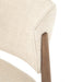 Close-up of a Detail view of Joren Dining Chair showcasing curved wood frame and cushioned seat on white background