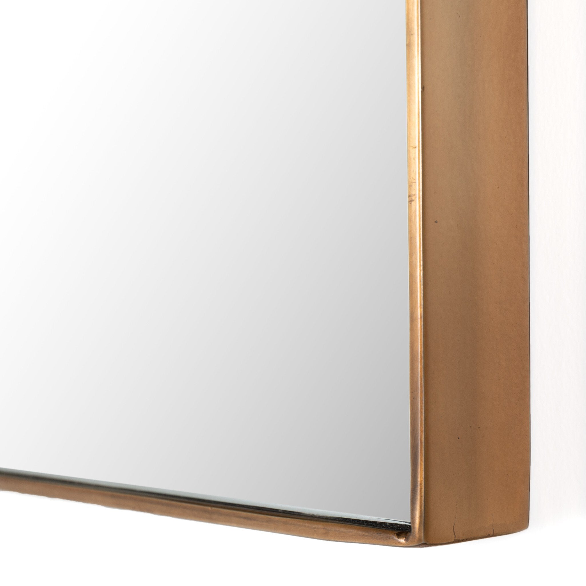 Close-up of the Georgina Small Mirror showing the hand-applied polished brass aluminum frame and clean square bottom