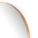 Close-up of the Georgina mirror's slender polished brass frame showing the refined modern edge
