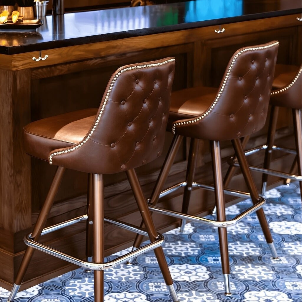 Close-up of the Hamilton stool’s hand-applied nailhead detailing and intricate button tufting for luxury commercial design