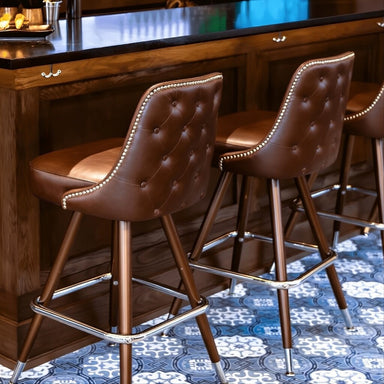 Close-up of the Hamilton stool’s hand-applied nailhead detailing and intricate button tufting for luxury commercial design