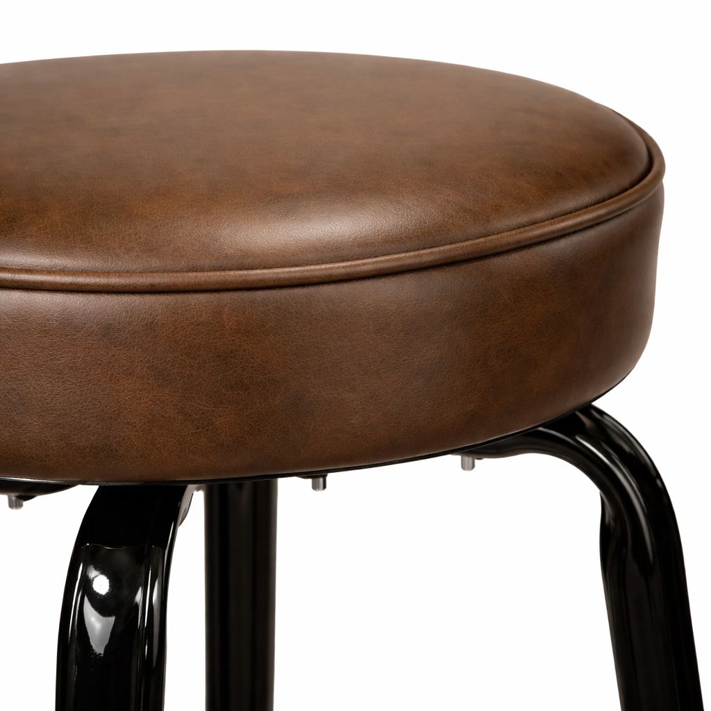 Close Detail Crossover Bar Stool by Social Design Supply Co: A modern sculptural steel bar stool with a padded round seat and refined architectural frame for upscale hospitality bars
