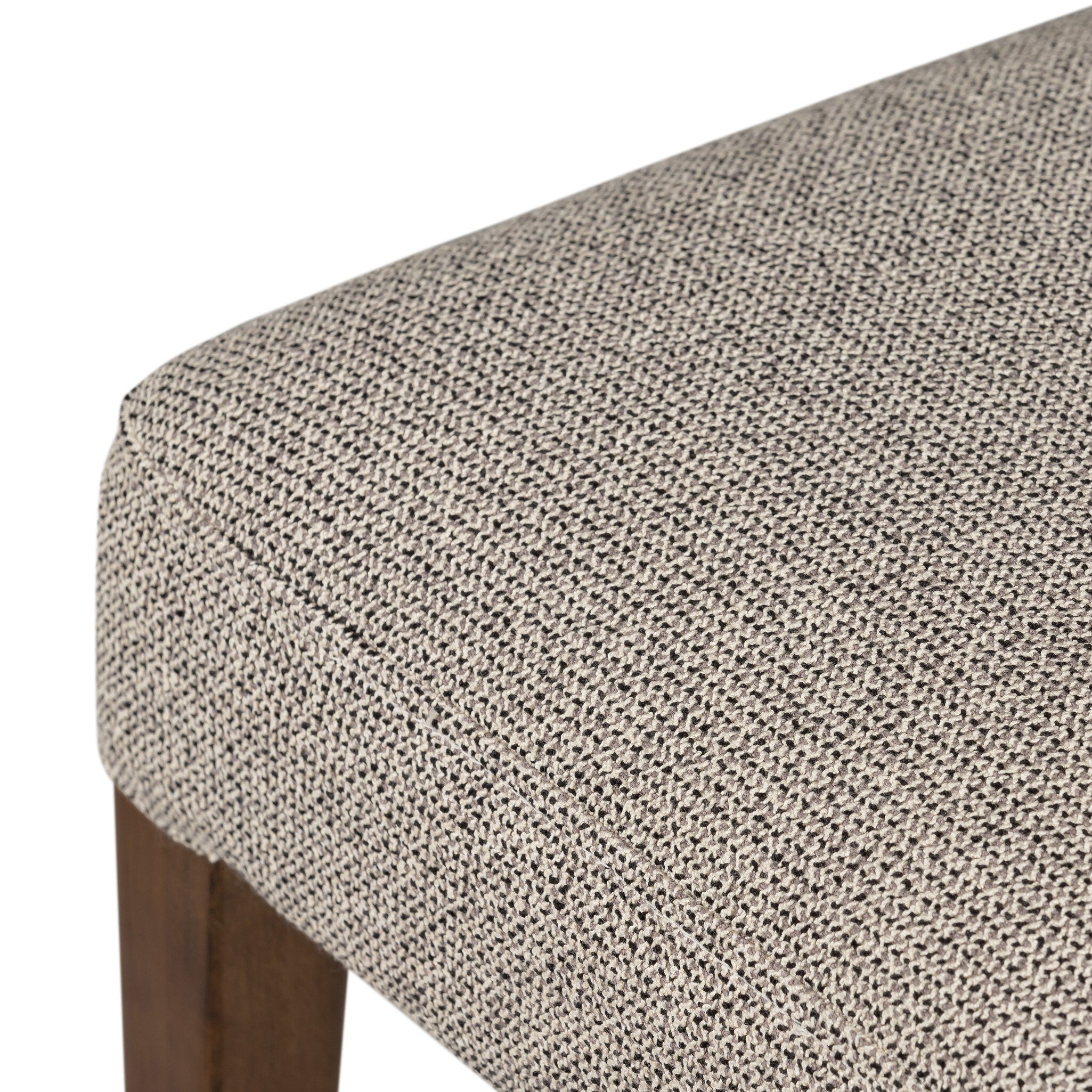 Armless dining chair seat cushion close-up in beige woven fabric with rounded edge