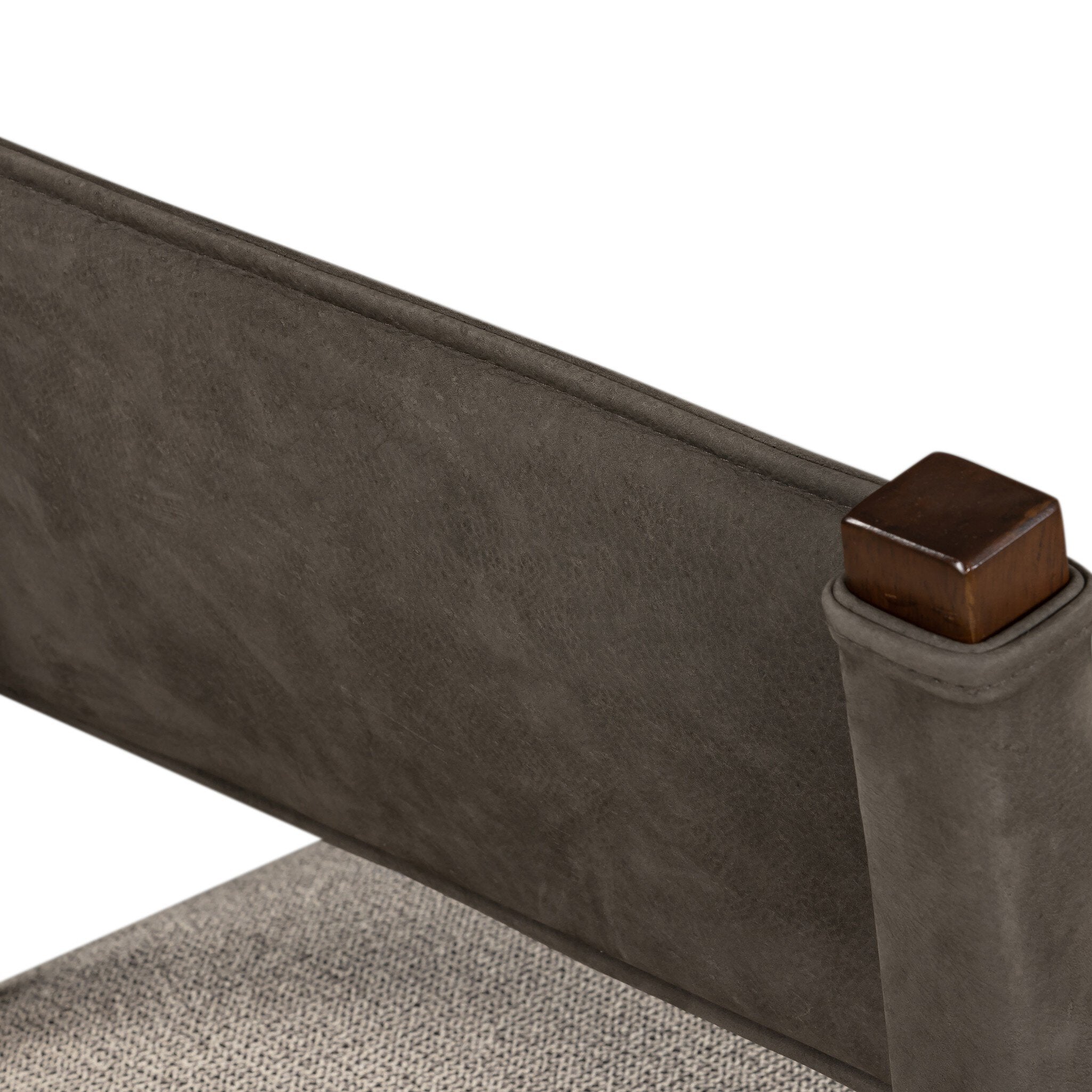 Armless dining chair backrest close-up with dark leather-look panel and wood corner cap