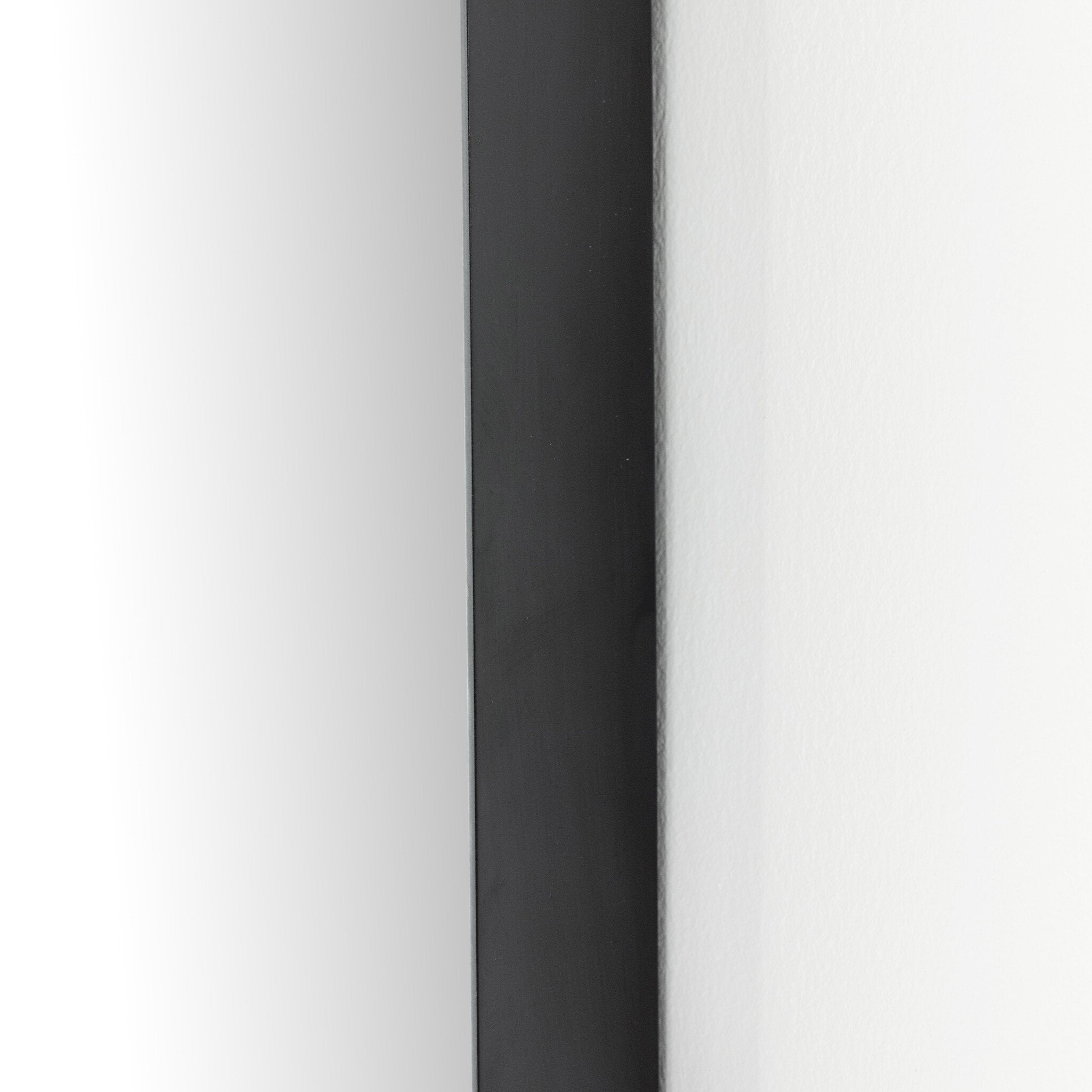 Close Textured view of the Georgina iron matte black arch mirror showcasing the thin industrial-style profile