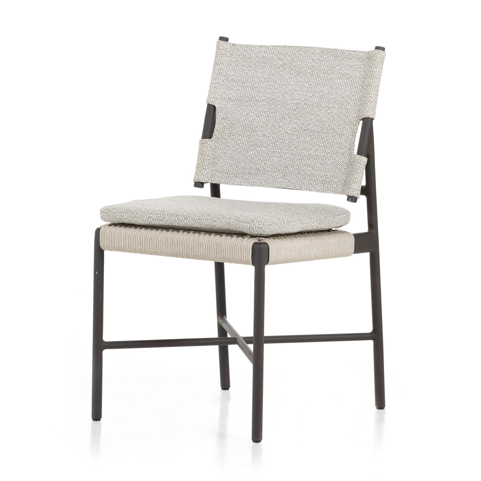 Close angle detail Miller outdoor performance dining chair with a light taupe fabric cushion, wrap detail, and a crossed bronze aluminum frame.