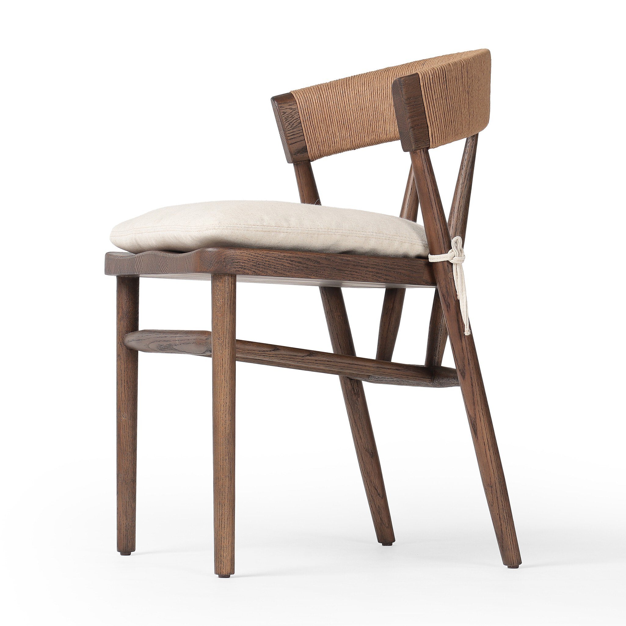 Close Angled Buxton Armless Dining Chair in solid oak with a hand-wrapped paper rush back and Savile Flax seat