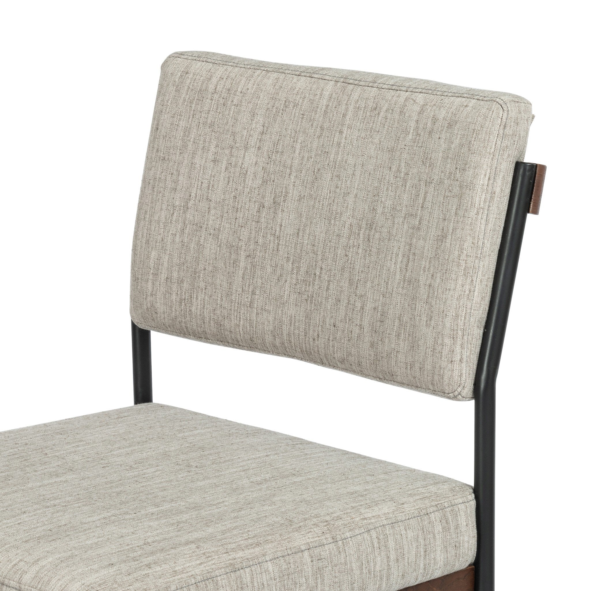 Close-up of light gray upholstered backrest on a black metal counter stool