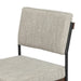 Close-up of light gray upholstered backrest on a black metal counter stool