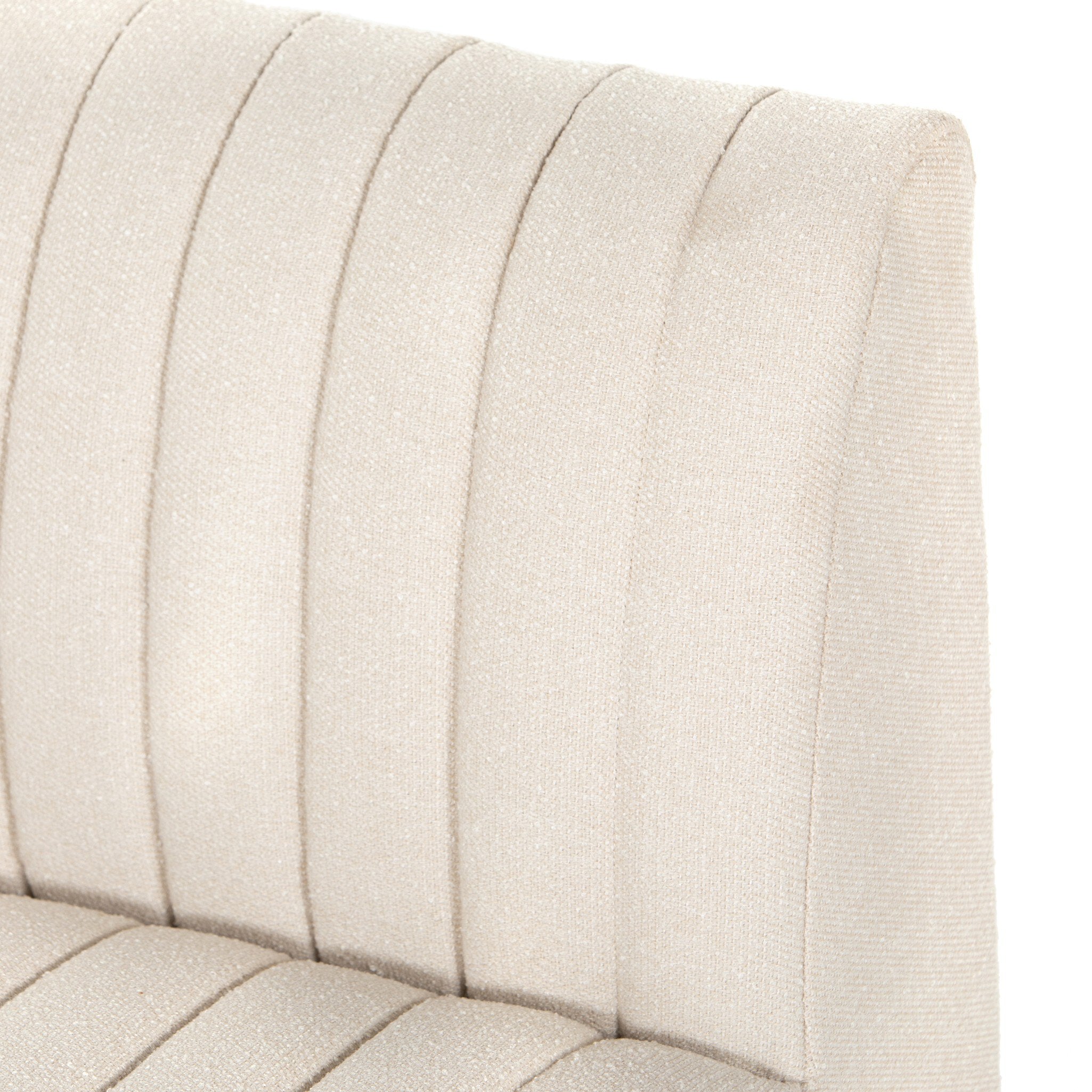 Close-up of a beige upholstered headboard with stitching details on a white background