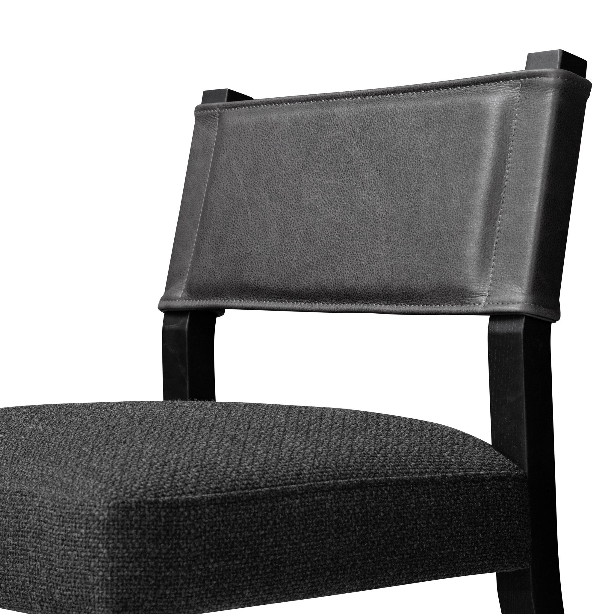 Armless dining chair close-up of dark upholstered backrest and gray seat cushion