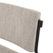 Close-up of a gray upholstered chair with a wooden armrest on a white background. Benton Dining Chair in Savile Flannel performance fabric featuring a slim iron frame and wood bar.