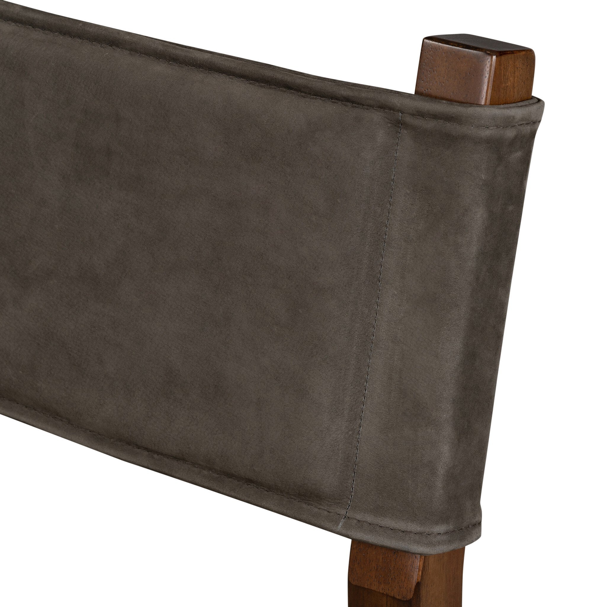 Armless dining chair backrest close-up in dark leather-look with stitched edge and cap