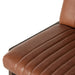 Brown upholstered seat cushion with vertical stitched channels on a counter stool