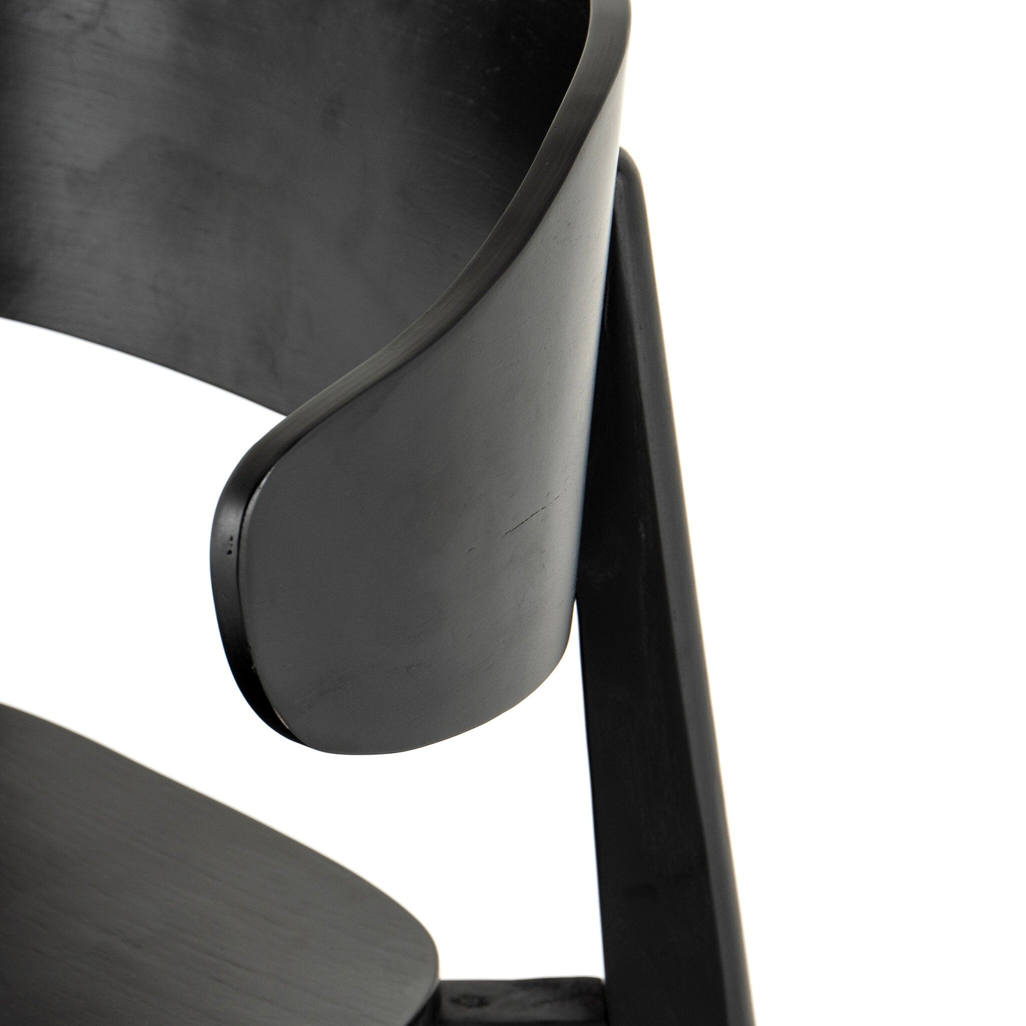 Black armless dining chair with curved backrest and slanted legs.