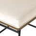 Cream cushion corner with welt stitching and dark wood base on black metal legs