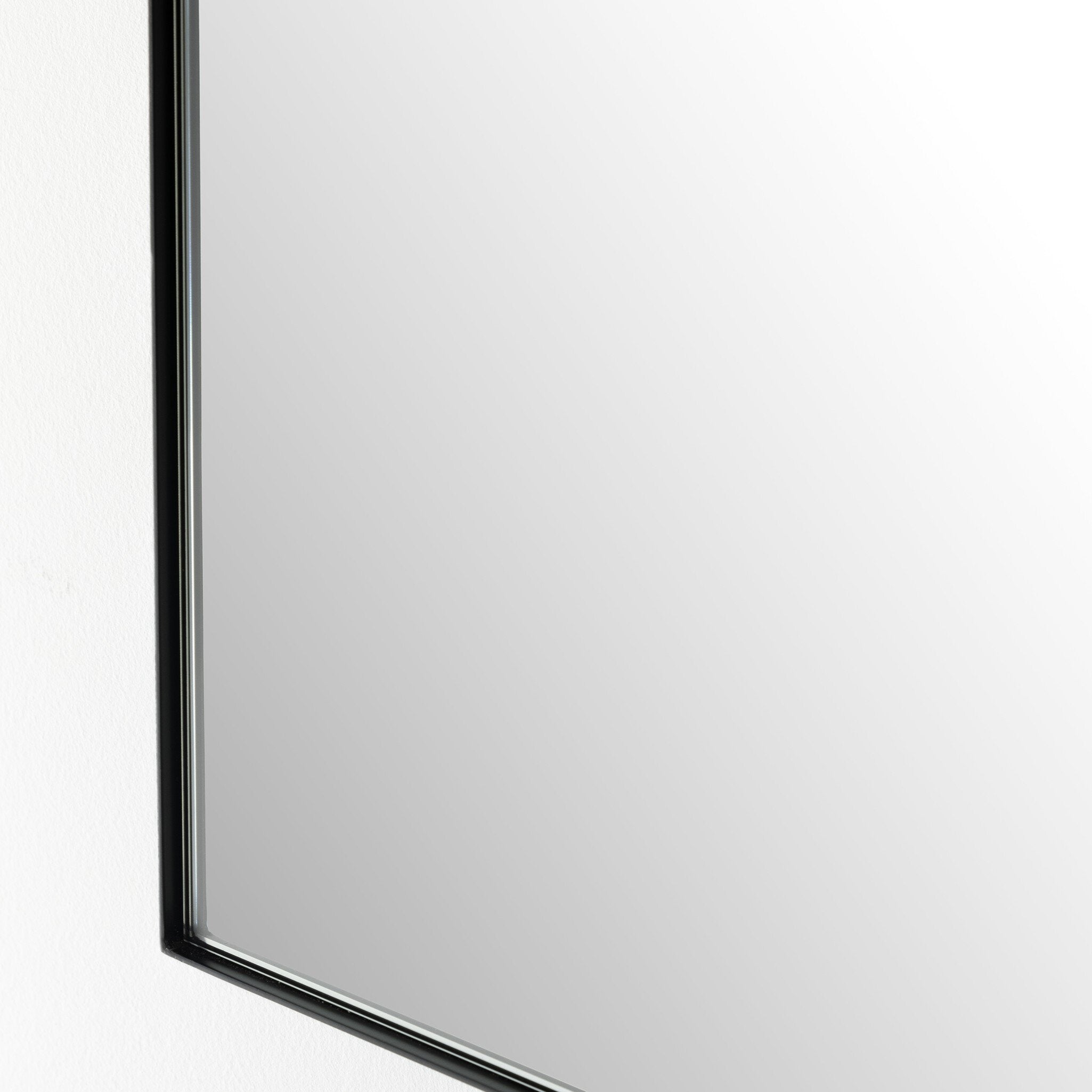 Corner Textured view of the Georgina iron matte black arch mirror showcasing the thin industrial-style profile