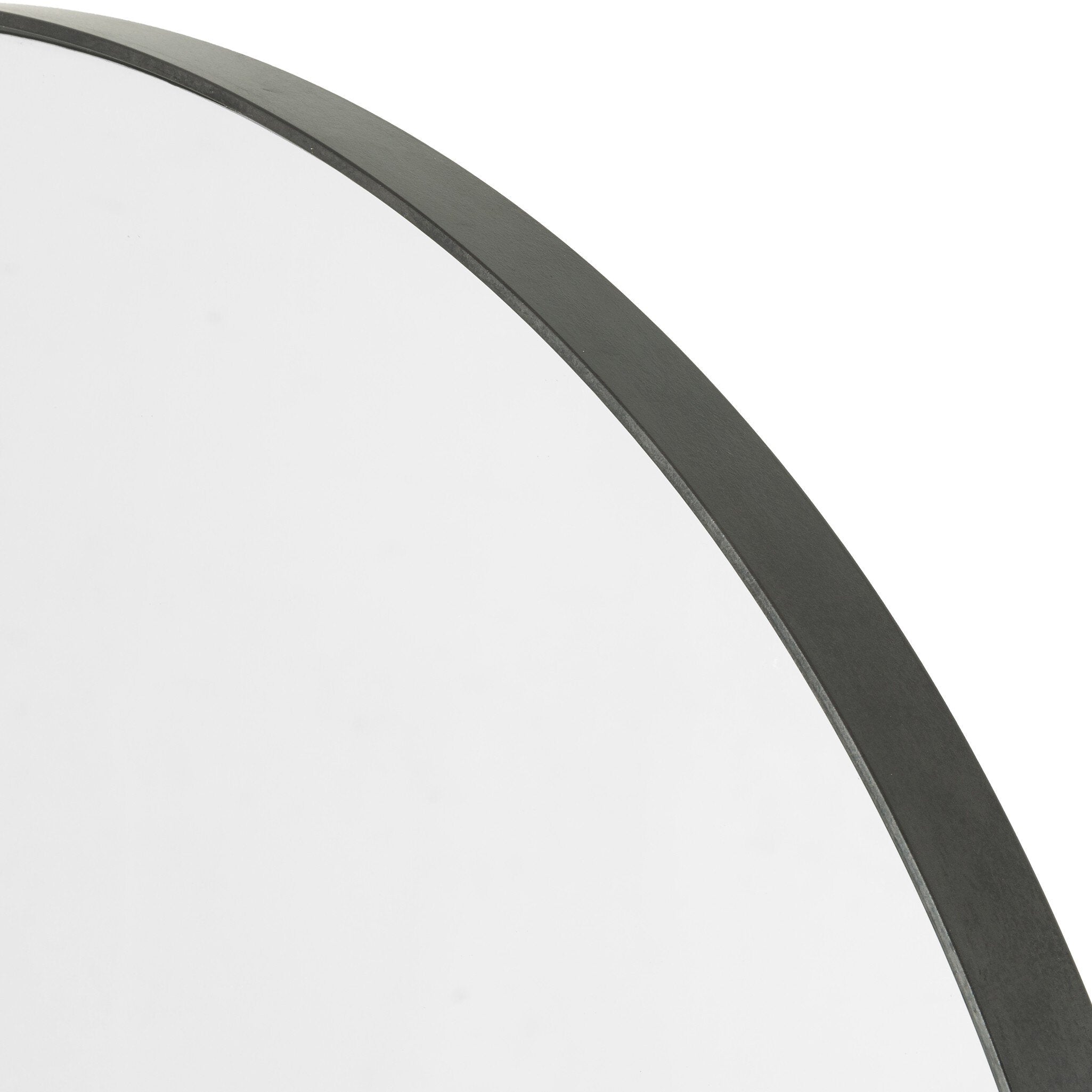Corner detail Bellvue round mirror with a classic black iron frame hanging 
