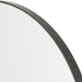 Corner detail Bellvue round mirror with a classic black iron frame hanging 