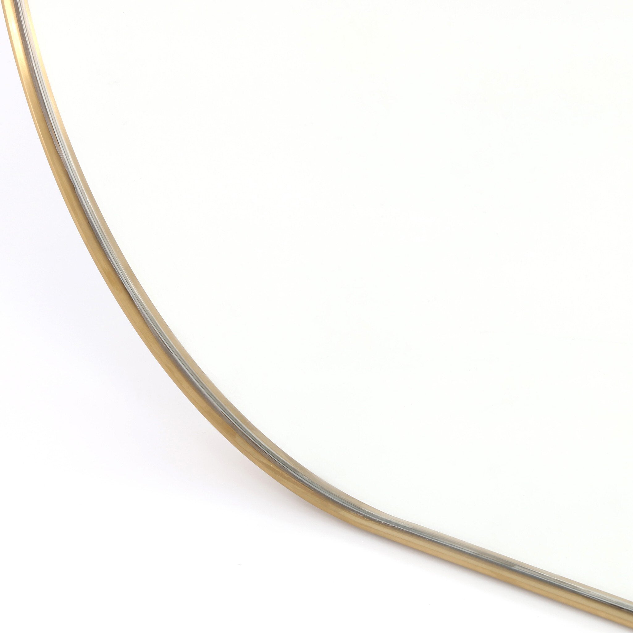 Corner detail Bellvue square mirror with softly rounded corners and a polished brass stainless steel frame