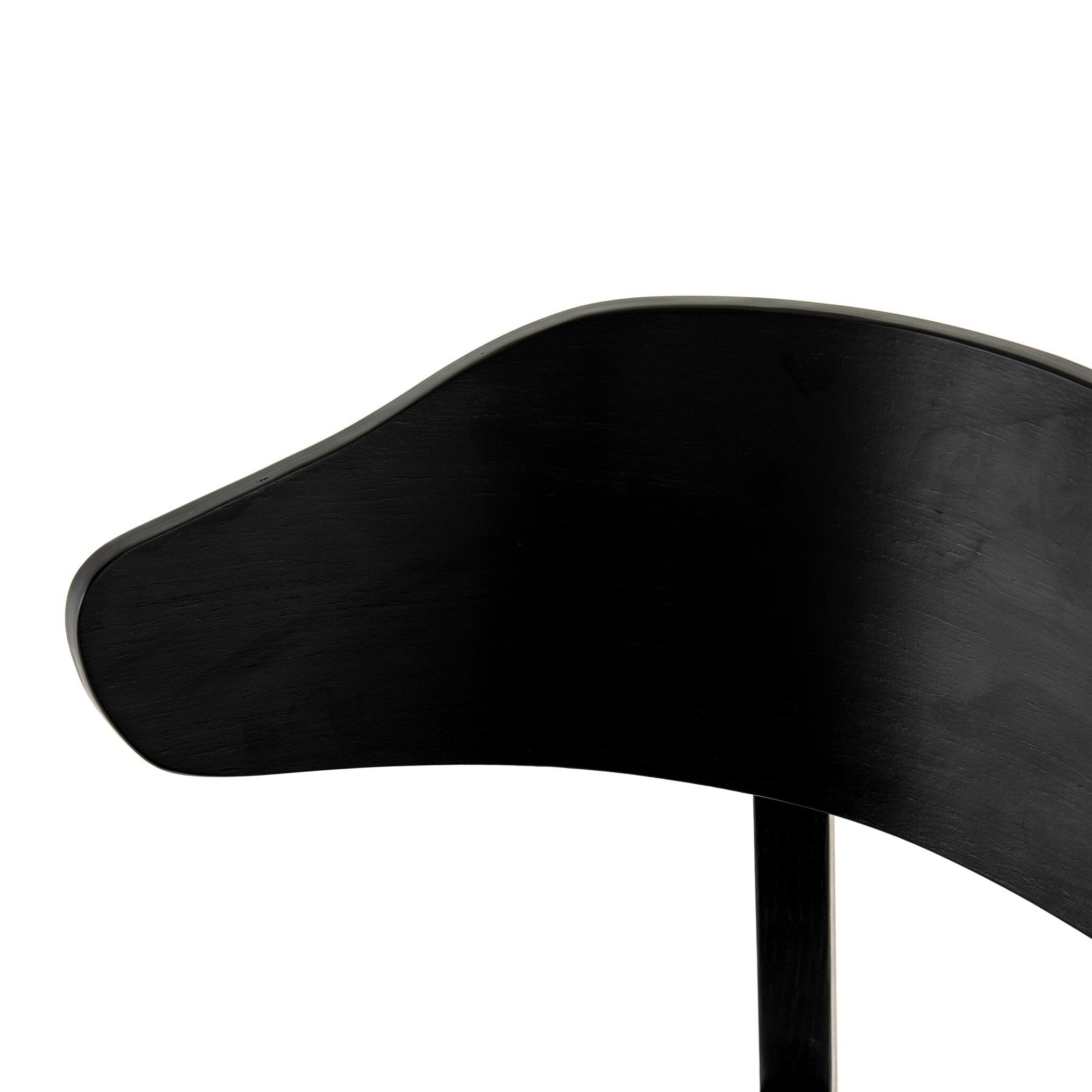 Black armless dining chair close-up of curved black backrest