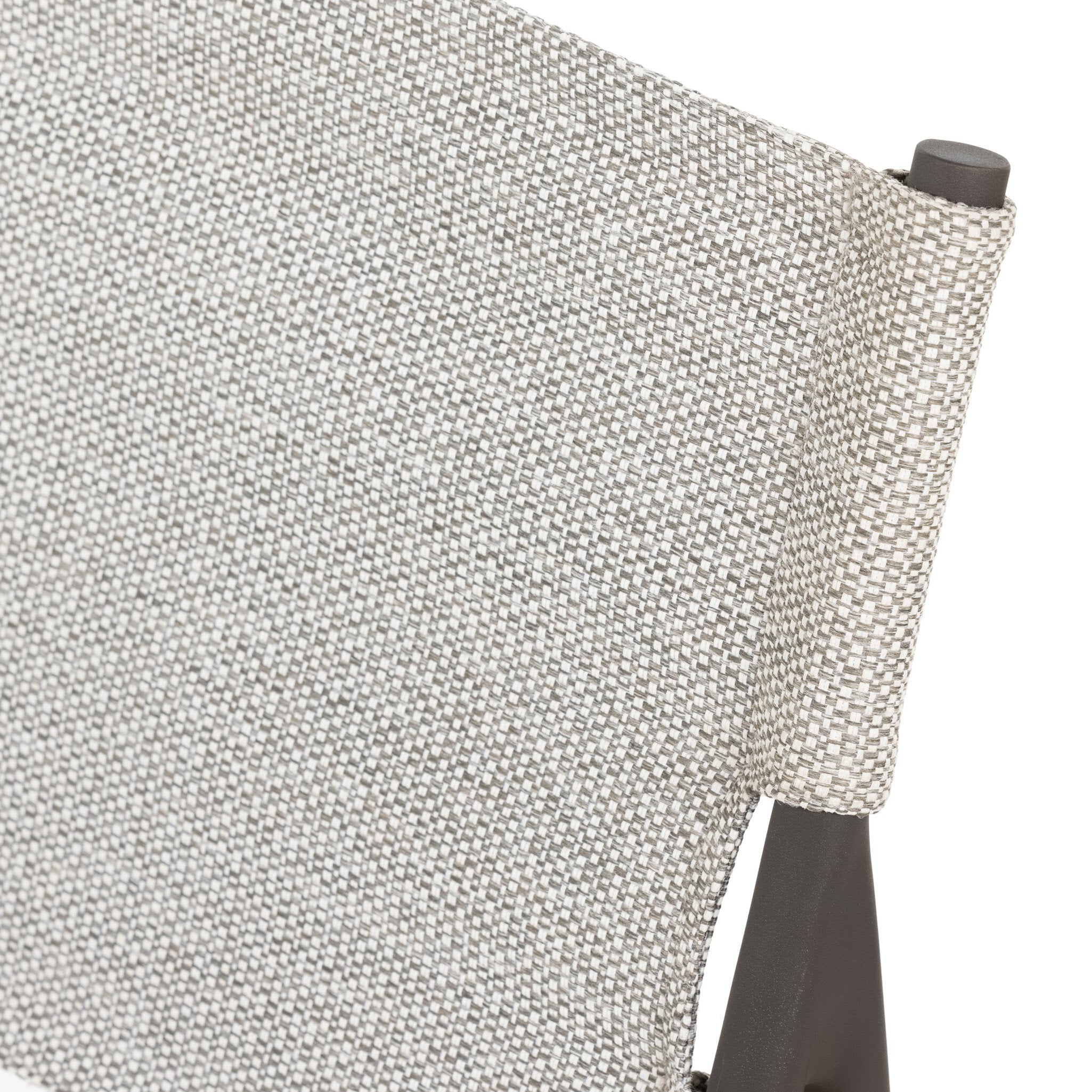 Corner detail of contract grade fabric Miller outdoor performance dining chair with a light taupe fabric cushion, wrap detail, and a crossed bronze aluminum frame.