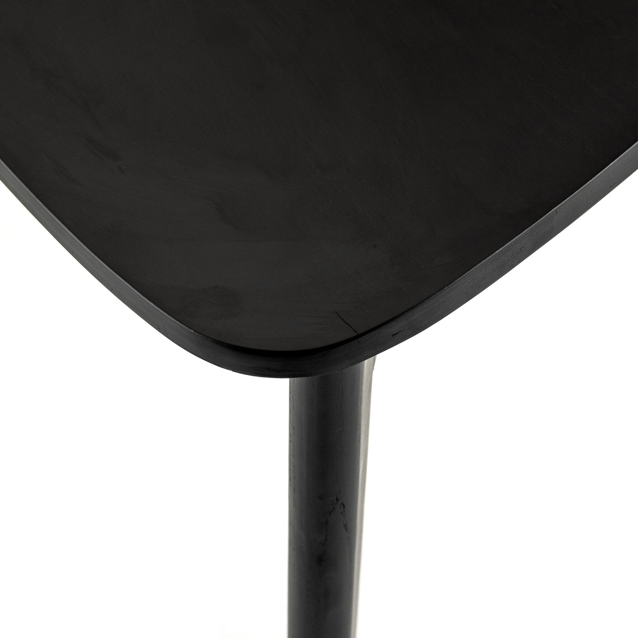 Black armless dining chair seat with rounded front edge and tapered legs.