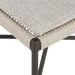 Corner close-up of woven Miller outdoor performance dining chair with a light taupe fabric cushion, wrap detail, and a crossed bronze aluminum frame.