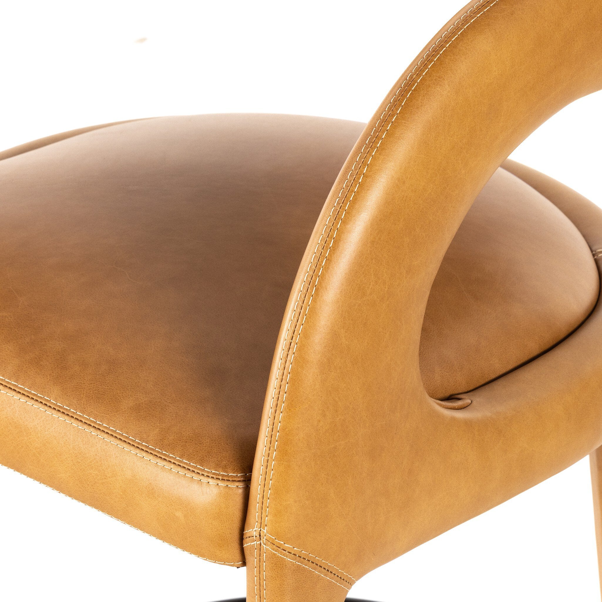 Tan counter stool with curved arms, padded seat, and visible seam stitching