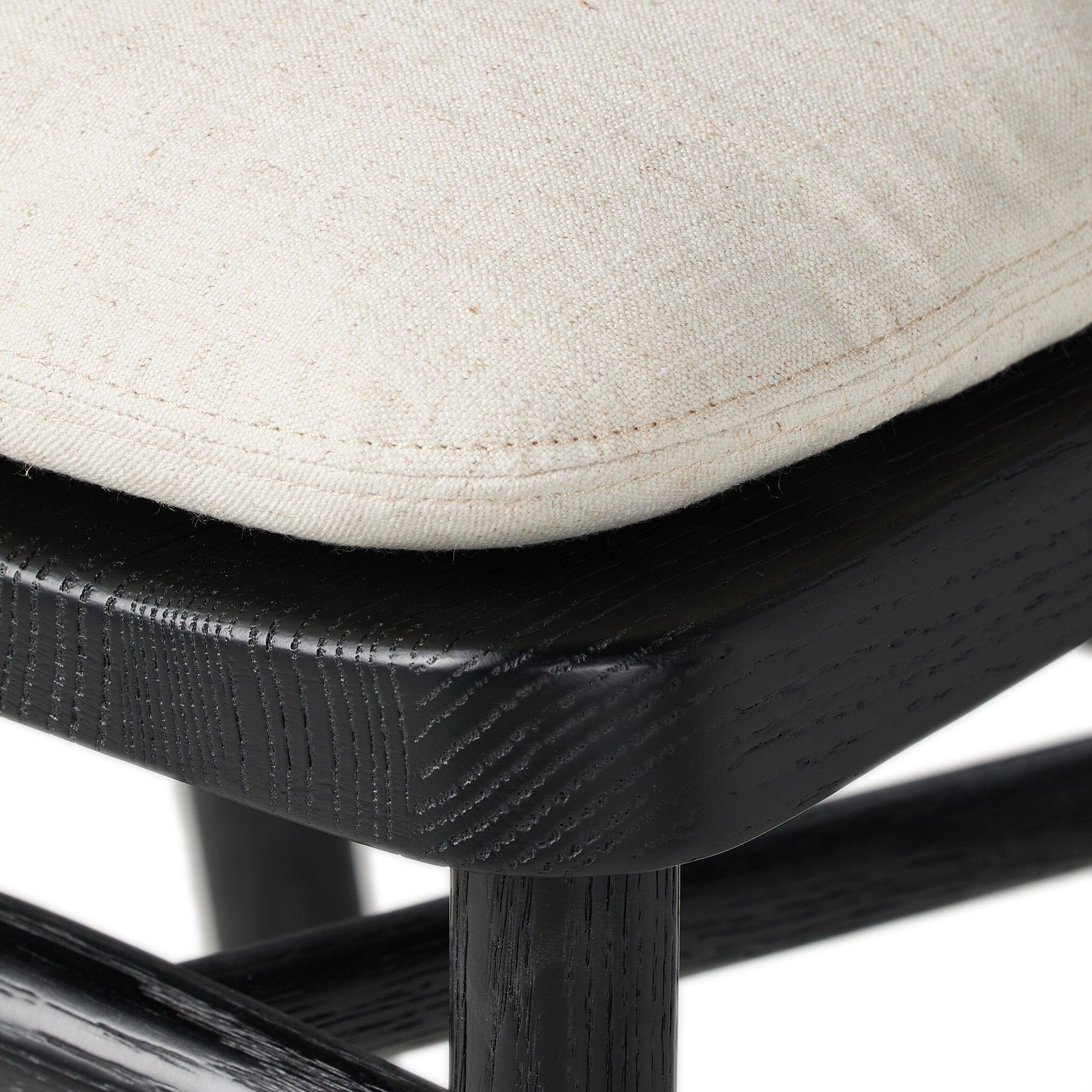 Bar stool close-up of cream seat cushion and black base frame