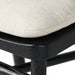Bar stool close-up of cream seat cushion and black base frame