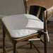 Cream padded bar stool seat with wooden frame and tied cushion