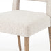 Armless dining chair armrest-free seat in light camel fabric, with tapered wooden legs.