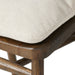 Cream seat cushion edge on brown wooden bar stool frame