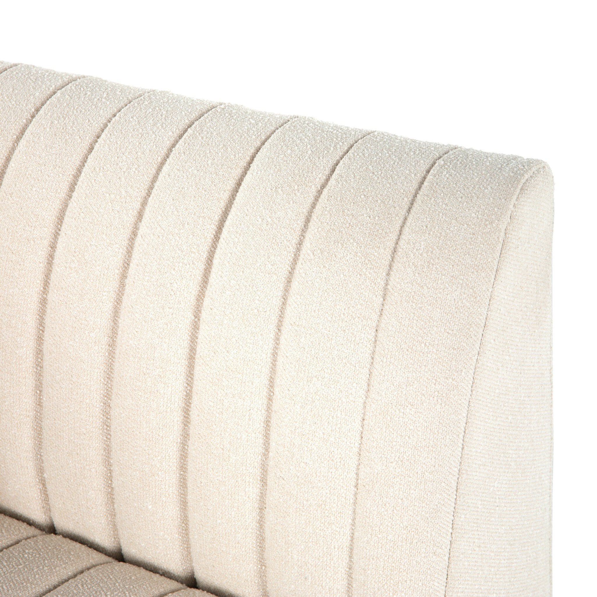Close-up of a beige Augustine custom upholstered chair with a textured pattern on a white background