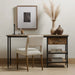 Armless dining chair in light camel fabric upholstery with wooden legs, styled indoors.