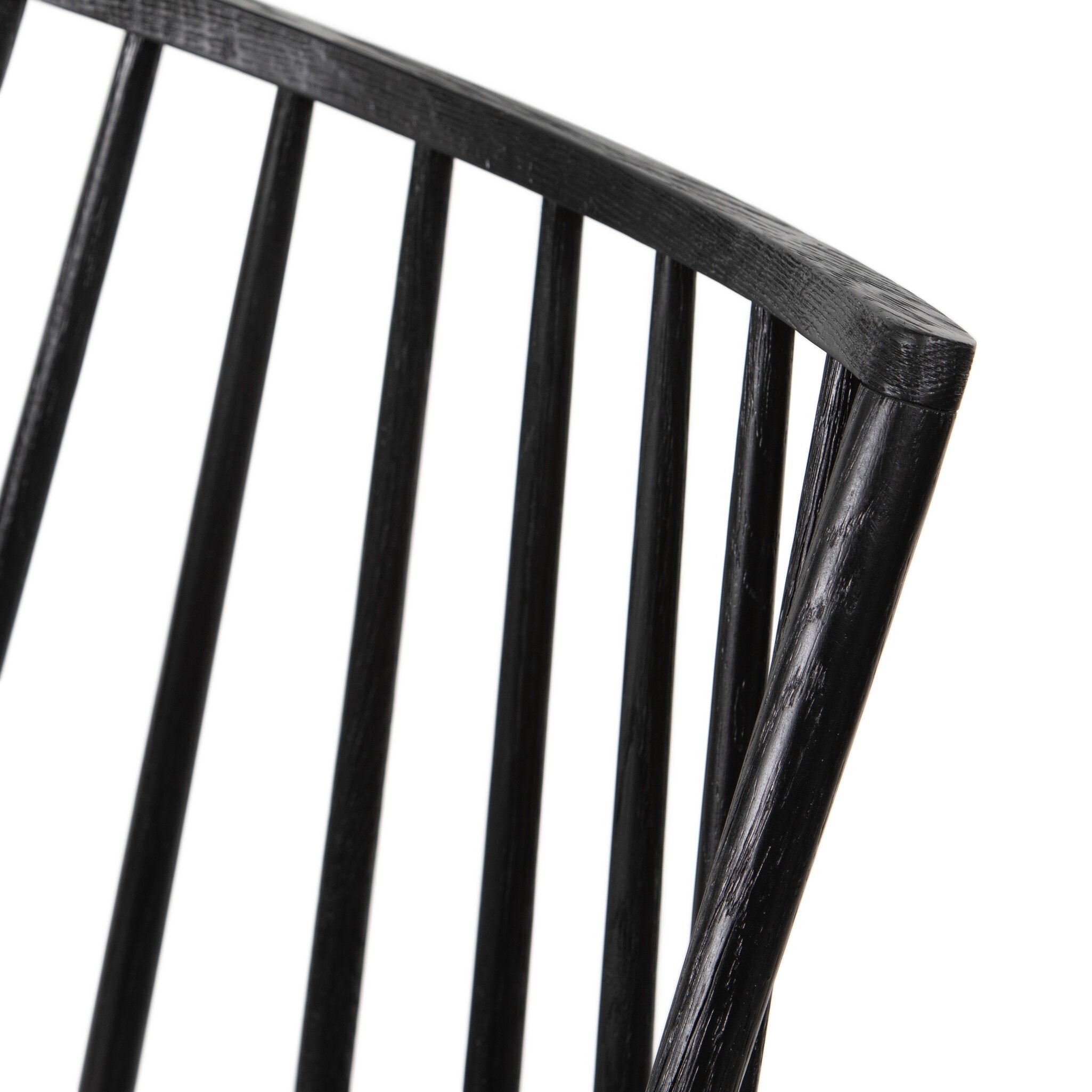 Close-up of dark wood chair back slats and curved top rail, smooth black finish