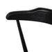 Close-up of a black chair armrest on a white background. Detail Ripley Dining Chair in Black Oak with mid-century Windsor-style sculptural silhouette.