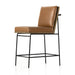 Counter stool with tan leather-look seat and tall back, black metal frame and footrest