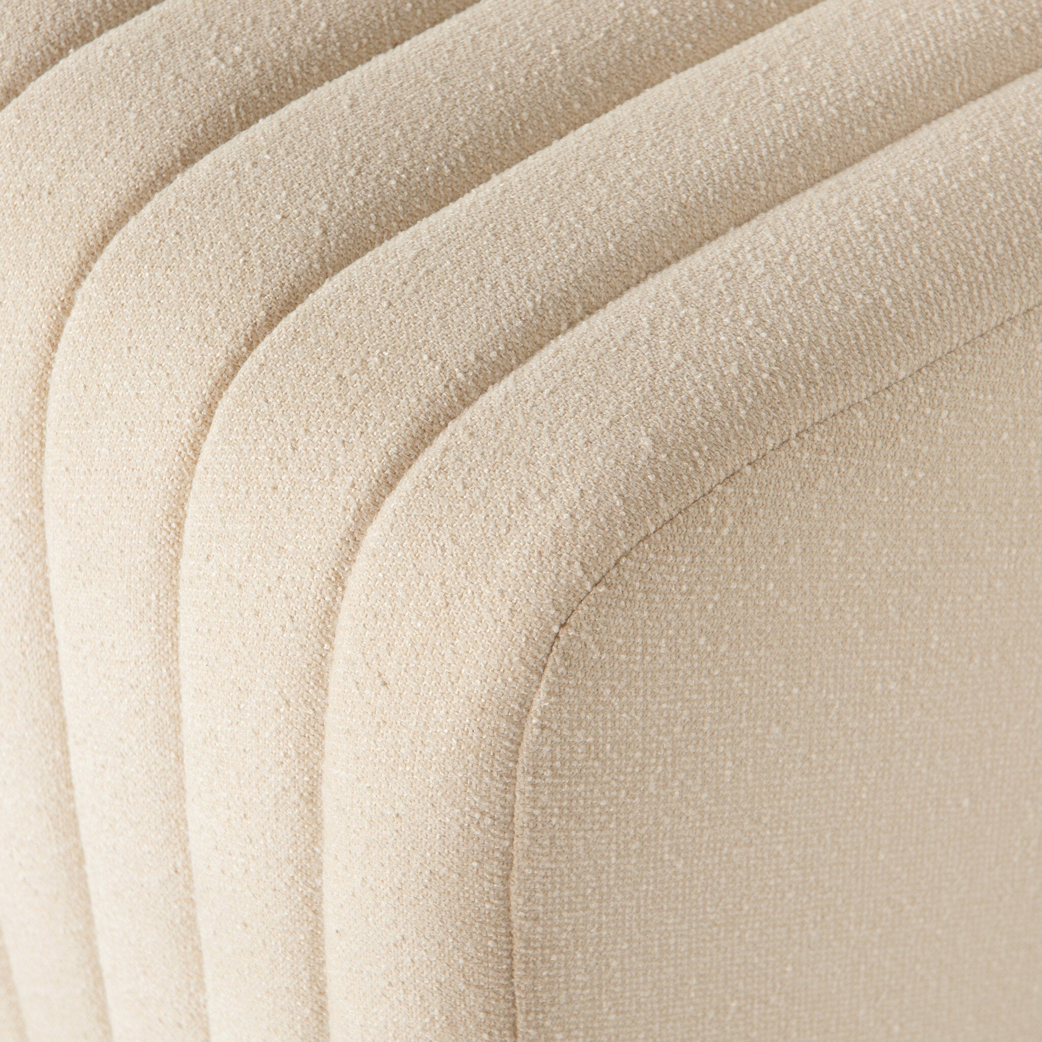 Close-up Custom Augustine dining banquette in neutral performance fabric with high-back tufted detailing and wood base.
