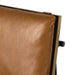 Close-up of tan leather-look counter stool upholstery with side hardware and wood frame