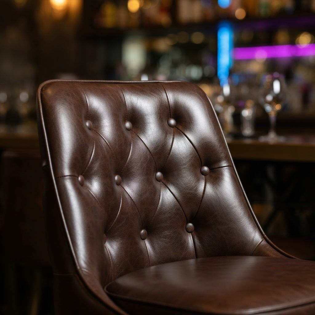 Detailed Fudge Coventry Bolted Floor-Mounted Bar Counter Stool with tufted vinyl detail and polished chrome pedestal base