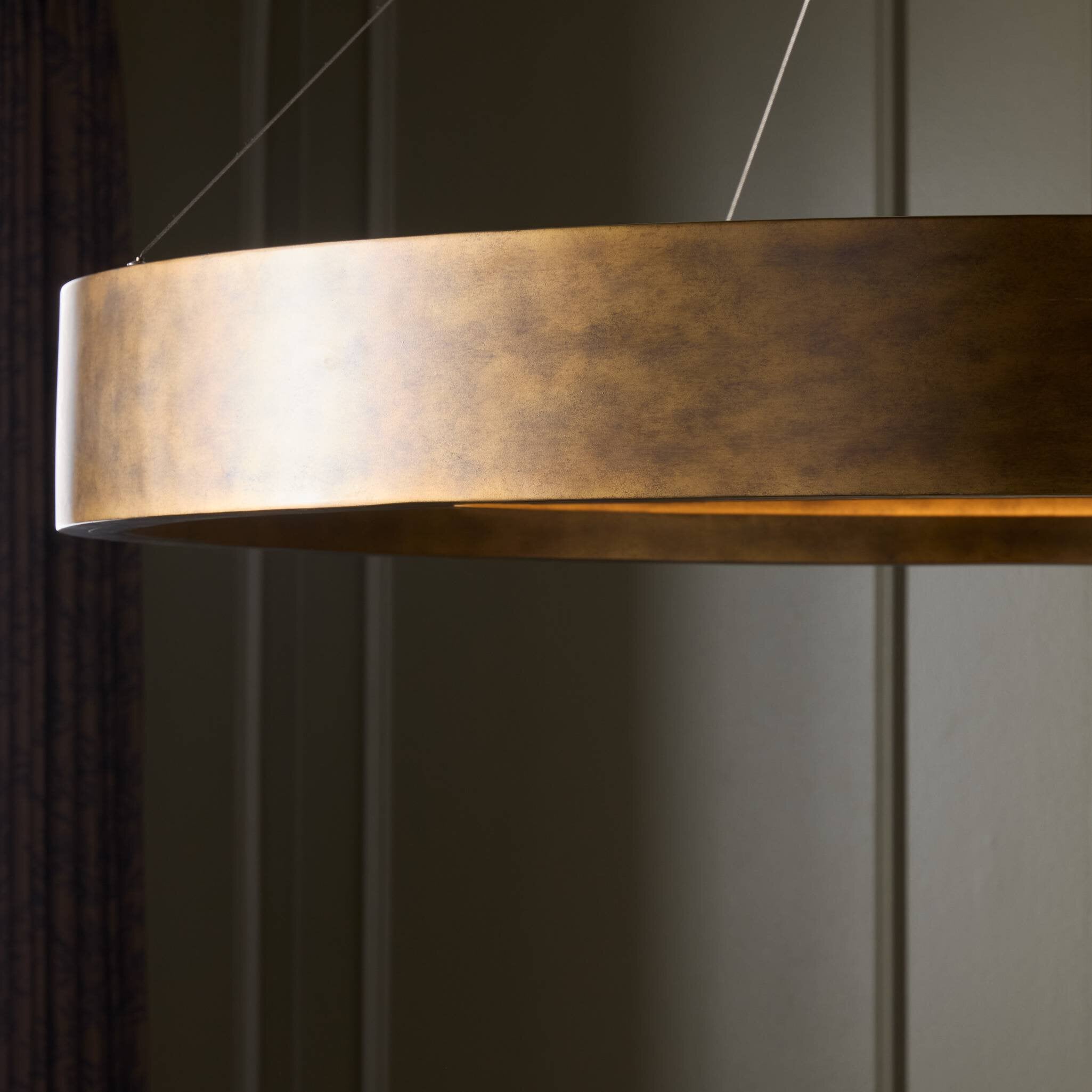 Detailed Light Baum Chandelier with a rounded dark-finished frame and bronzed stainless steel suspension