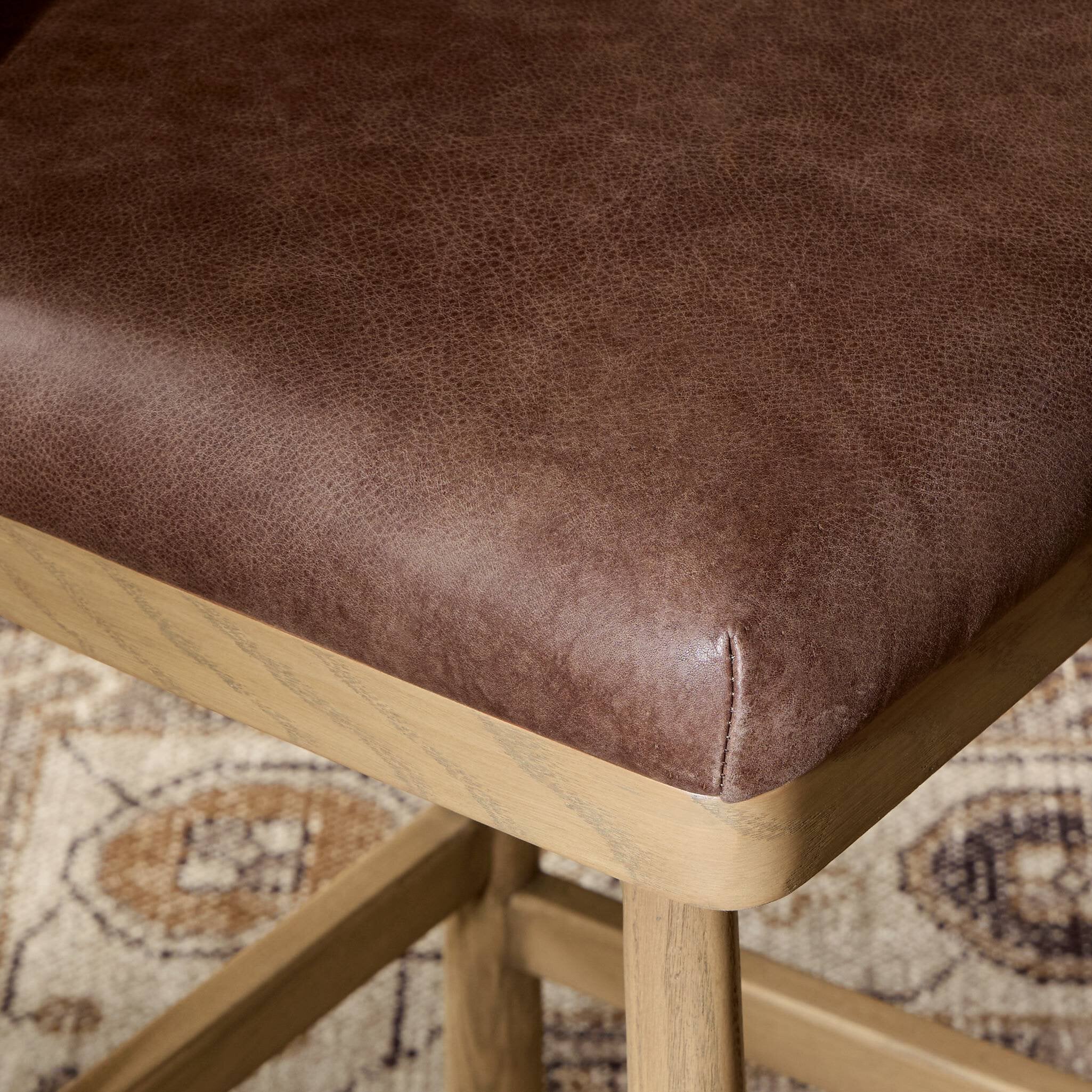 Detailed cushion with wooden backrest in a blurred indoor setting