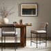 Upholstered counter stool in light gray fabric with black metal legs and footrest