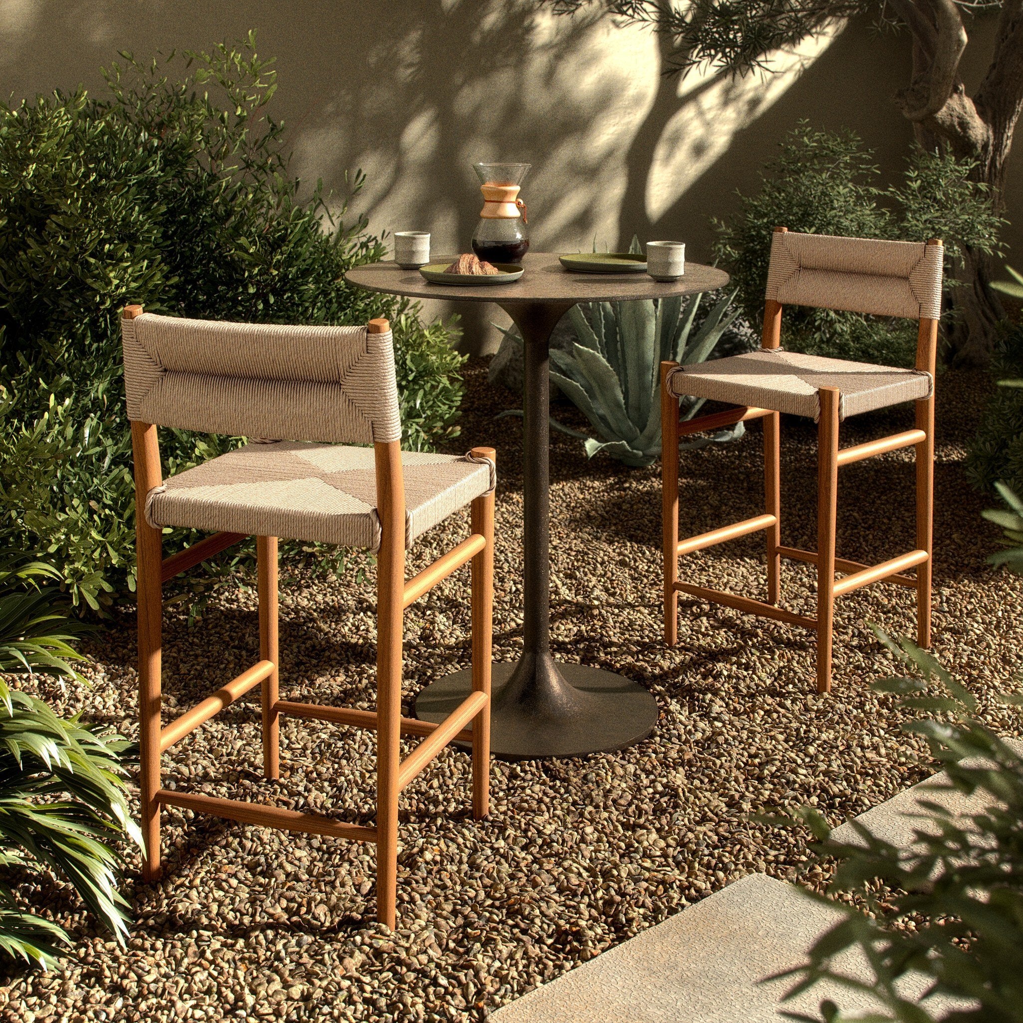 Outdoor bar counter stool in vintage white with woven back, armrests, and wood legs